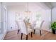 Bright breakfast nook with white trim, wood floors, and a modern light fixture at 716 Sunfield Nw Dr, Lilburn, GA 30047