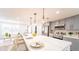 Open-concept kitchen with a large island, stainless steel appliances, and gray cabinets at 716 Sunfield Nw Dr, Lilburn, GA 30047