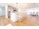 Bright kitchen with white island, barstool seating, stainless steel appliances, and view into the dining room at 716 Sunfield Nw Dr, Lilburn, GA 30047