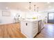 Kitchen island with white cabinetry, stainless steel dishwasher, and gold hardware at 716 Sunfield Nw Dr, Lilburn, GA 30047