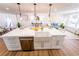 Kitchen island with marble countertop and a farmhouse sink looking into the living room at 716 Sunfield Nw Dr, Lilburn, GA 30047