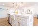 Bright kitchen island featuring stainless steel appliances, a farmhouse sink, and stylish gold fixtures at 716 Sunfield Nw Dr, Lilburn, GA 30047