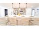 Kitchen island with white marble countertop, stylish pendant lights, and seating at 716 Sunfield Nw Dr, Lilburn, GA 30047