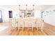 A kitchen with a large center island, pendant lighting, and light wood-look floors at 716 Sunfield Nw Dr, Lilburn, GA 30047