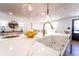 Bright kitchen featuring an island with a modern sink and gold fixtures at 716 Sunfield Nw Dr, Lilburn, GA 30047