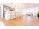 Bright kitchen with island and barstool seating along with stainless steel appliances and easy access to the dining room at 716 Sunfield Nw Dr, Lilburn, GA 30047