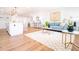 Open-concept living space with sleek wood flooring, modern decor, and a charming kitchen island at 716 Sunfield Nw Dr, Lilburn, GA 30047
