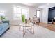 Bright living room with a neutral rug, view of entry, and large window that allows for natural light at 716 Sunfield Nw Dr, Lilburn, GA 30047