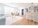 Light-filled living room with kitchen island and breakfast bar seating in the background; also features a mudroom at 716 Sunfield Nw Dr, Lilburn, GA 30047
