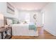 Well-lit main bedroom with natural light, hardwood flooring, and a comfortable bed at 716 Sunfield Nw Dr, Lilburn, GA 30047