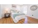 Comfortable main bedroom with decor, natural light, and hardwood flooring at 716 Sunfield Nw Dr, Lilburn, GA 30047