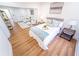Main bedroom with a view to the sitting room, neutral furniture, and hardwood flooring at 716 Sunfield Nw Dr, Lilburn, GA 30047