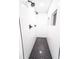 Modern shower room with black and white tiles, dual shower heads, and built-in wall niches at 716 Sunfield Nw Dr, Lilburn, GA 30047
