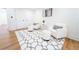 Sitting room with neutral furniture, decorative rug, hardwood floors and white walls at 716 Sunfield Nw Dr, Lilburn, GA 30047