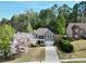 Aerial view of a two-story brick home featuring an attached garage, and charming front porch at 140 Kirkland Dr, Lawrenceville, GA 30044