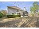 Backyard featuring a well-maintained lawn, mature trees, and a screened-in porch at 140 Kirkland Dr, Lawrenceville, GA 30044