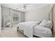 Bedroom with carpet features a queen-size bed, full-length mirror and window overlooking trees at 140 Kirkland Dr, Lawrenceville, GA 30044