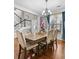 Bright and airy dining room featuring hardwood floors, a modern chandelier, and views of the staircase at 140 Kirkland Dr, Lawrenceville, GA 30044