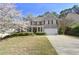 Traditional two-story brick home featuring a well-manicured lawn, attached garage, and charming front porch at 140 Kirkland Dr, Lawrenceville, GA 30044