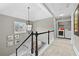 Upstairs hallway featuring carpet, a light fixture, and laundry room access at 140 Kirkland Dr, Lawrenceville, GA 30044