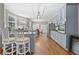 Modern kitchen with stainless steel appliances, grey cabinetry, and spacious island with seating at 140 Kirkland Dr, Lawrenceville, GA 30044