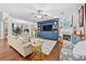 Open-concept living room featuring hardwood floors, a cozy fireplace, and ample seating for guests at 140 Kirkland Dr, Lawrenceville, GA 30044