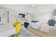 Bright main bedroom with a ceiling fan, natural light, and yellow desk chair at 140 Kirkland Dr, Lawrenceville, GA 30044