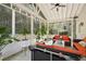 Sunroom with tile floors, string lights, and patio furniture provides a relaxing outdoor space at 140 Kirkland Dr, Lawrenceville, GA 30044