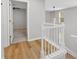 Bright hallway with hardwood flooring and a modern light fixture at 3417 Sable Chase Ln, Atlanta, GA 30349