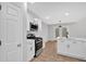 Bright kitchen features white cabinetry, stainless steel appliances, and a spacious island with seating at 3417 Sable Chase Ln, Atlanta, GA 30349