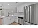 Modern kitchen with white cabinets, stainless steel appliances and stone countertops at 3417 Sable Chase Ln, Atlanta, GA 30349