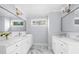 Bright bathroom featuring double vanity with marble countertop and modern fixtures, providing a luxurious feel at 420 Longs Peak, Johns Creek, GA 30022