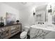 Powder room featuring a marble countertop vanity, framed art, and modern fixtures at 420 Longs Peak, Johns Creek, GA 30022