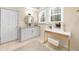 Bright bathroom featuring a single vanity with marble countertop and a makeup vanity with a lighted mirror at 420 Longs Peak, Johns Creek, GA 30022