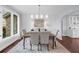 Bright dining room with large window, wood table, upholstered chairs, and built-in cabinets at 420 Longs Peak, Johns Creek, GA 30022