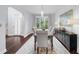Spacious dining room featuring hardwood floors, modern lighting, and access to the front door at 420 Longs Peak, Johns Creek, GA 30022