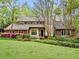 Charming exterior view of a stone and stucco home with a manicured lawn and mature trees at 420 Longs Peak, Johns Creek, GA 30022