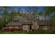 Charming exterior view of a stone and stucco home with a manicured lawn and mature trees at twilight at 420 Longs Peak, Johns Creek, GA 30022