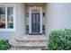 Elegant front door with decorative glass, flanked by sconces and manicured shrubbery at 420 Longs Peak, Johns Creek, GA 30022