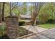 View of the home from the street featuring a stone mailbox, driveway, and a lush, green front yard at 420 Longs Peak, Johns Creek, GA 30022