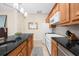 Bright kitchen offers stainless steel appliances, stone countertops, tile backsplash, and wooden cabinets at 420 Longs Peak, Johns Creek, GA 30022
