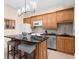 Well-lit kitchen features a breakfast bar, stainless steel appliances, and beautiful wood cabinetry at 420 Longs Peak, Johns Creek, GA 30022