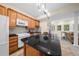 Well-lit kitchen features an island, stainless steel appliances, and views of living room at 420 Longs Peak, Johns Creek, GA 30022