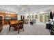 Open-concept basement living area including dining area, and cozy seating area with sofa, and bright walkout doors at 420 Longs Peak, Johns Creek, GA 30022