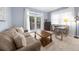 Inviting living room featuring a comfortable sofa, a rustic coffee table, and a desk near the french doors at 420 Longs Peak, Johns Creek, GA 30022