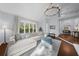 Spacious living room featuring hardwood floors, a statement light fixture, and large windows at 420 Longs Peak, Johns Creek, GA 30022
