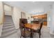 View of living room, stairway and dining area with wooden table, chairs and staircase at 420 Longs Peak, Johns Creek, GA 30022