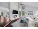 Cozy living room featuring a fireplace, shiplap accent wall, and hardwood floors at 420 Longs Peak, Johns Creek, GA 30022