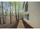 Sideyard view featuring a brick path and forest view at 420 Longs Peak, Johns Creek, GA 30022