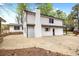 The back of the home showcases white shingle siding, a stone paver patio and a chimney at 5361 Seaton Way, Dunwoody, GA 30338